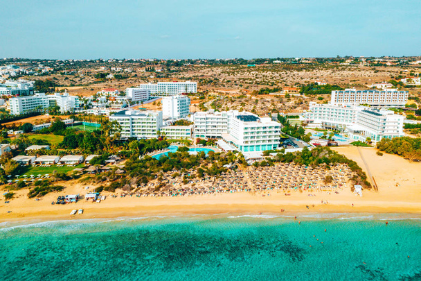 Nissi beach in Ayia Napa, clean aerial photo of famous tourist beach in Cyprus. The best resort area of Cyprus, Nissi beach, the hotels, gulfs, parks. - Zdjęcie, obraz
