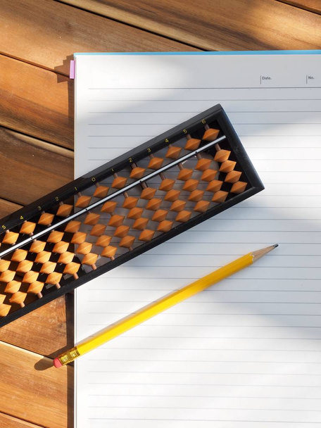 Asian analog calculator abacus and Notebooks and pencils - Zdjęcie, obraz