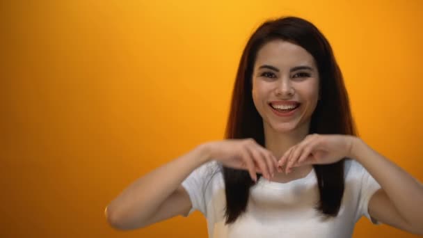 Beautiful girl throwing back hair and smiling to camera, enjoying happy life - Filmagem, Vídeo