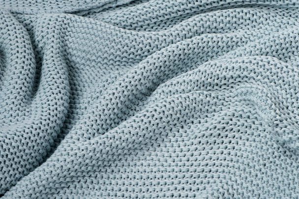 blue knitted plaid close-up wavy textured background  - Zdjęcie, obraz