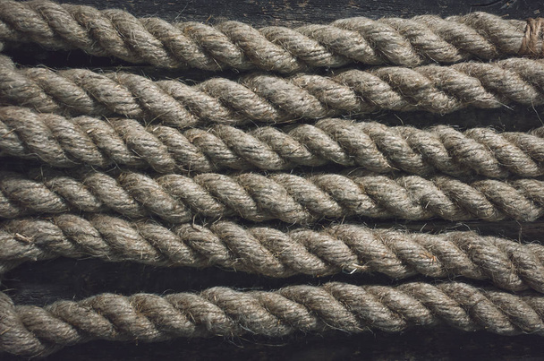 Rope on the wooden surface background. - Фото, зображення