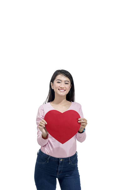 Young asian woman holding red paper hearts posing isolated over white background. Valentines day - Fotografie, Obrázek