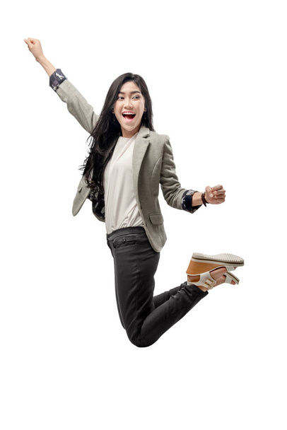 Excited asian business woman raised arm and jump to the sky posing isolated over white background - Foto, Imagem