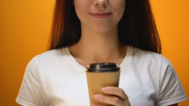 Girl taking off lid from plastic cup, tips to drink hot coffee properly, closeup - Materiaali, video