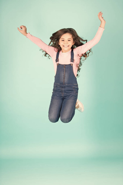Happy child in jeans overall jump, fashion - Foto, afbeelding
