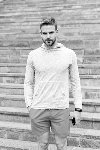 Workout concept. Young man stand on steps before workout outdoor. Morning workout. Workout not breakfast - Foto, Bild