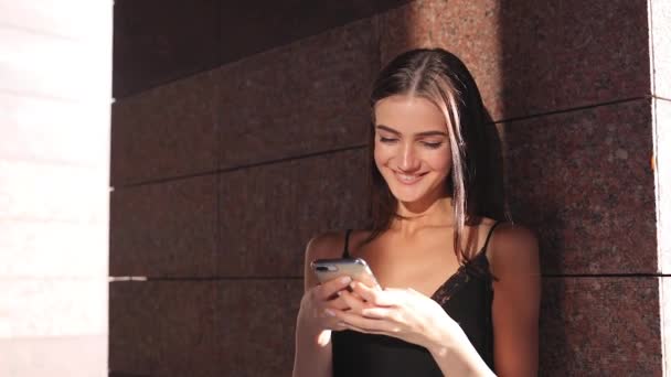 Smiling Woman With Phone. Girl Using Smartphone Outdoors - Кадри, відео