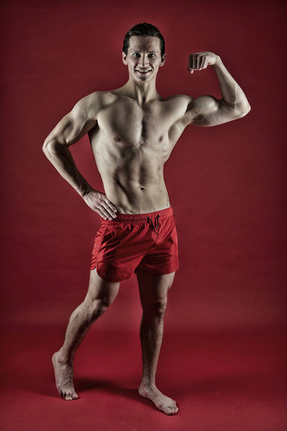 Satisfied with his workout. fit your body and lose weight. Fitness man exercising in gym. Athlete before workout. Sport and fitness. Athlete or sportsman in red shorts. Muscular man with strong body - Foto, Imagen
