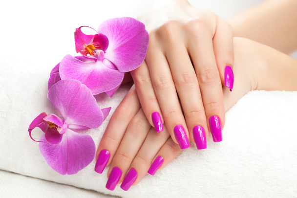 female hands with fragrant orchid and towel. - Foto, Imagem