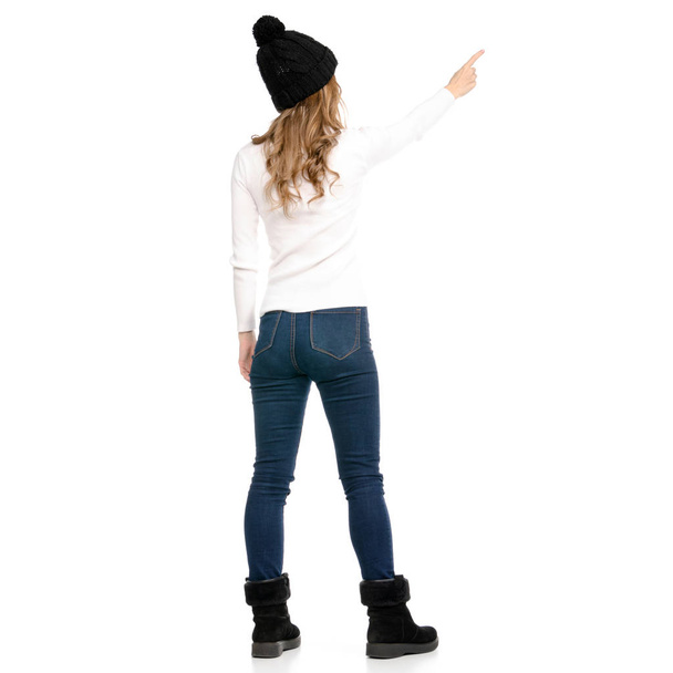 Beautiful woman in sweater jeans hat cold showing - Foto, immagini