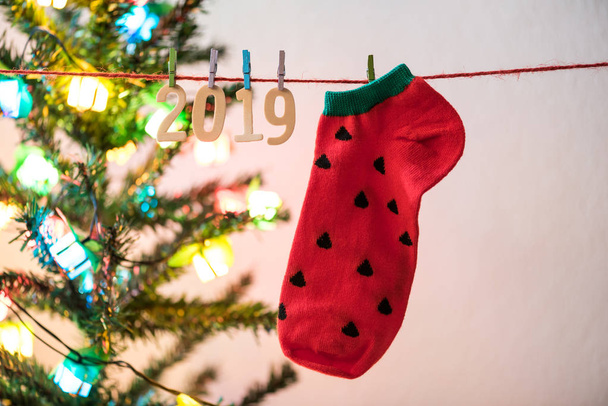 wood number 2019 and red sock hanging on a clothesline  for happy new year - Foto, Imagem