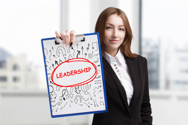 Business, technology, internet and networking concept. Young entrepreneur showing keyword: leadership - 写真・画像