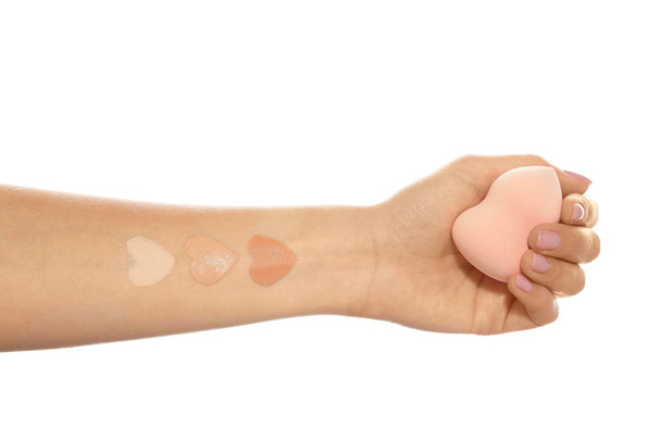 Woman with different foundation swatches on her hand against white background, closeup - Valokuva, kuva