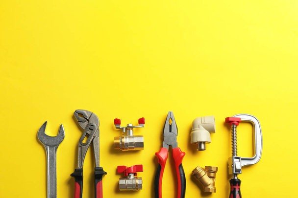 Flat lay composition with plumber's tools and space for text on color background - 写真・画像