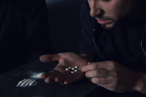 Young addicted man taking drugs, focus on hands - Photo, image