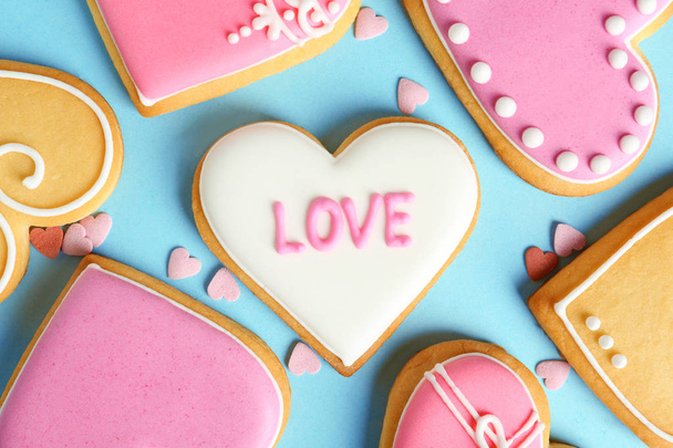 Composition with decorated heart shaped cookies on color background, top view. Valentine's day treat - Photo, Image