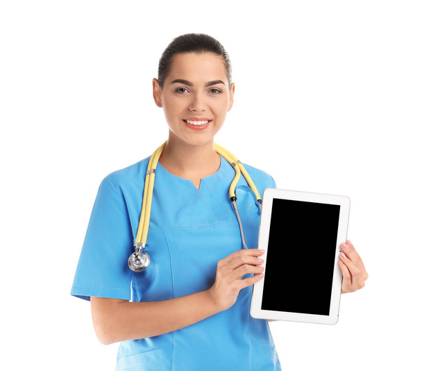 Portrait of young medical assistant with stethoscope and tablet on white background. Space for text - Фото, изображение
