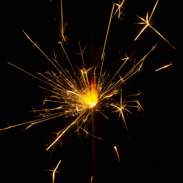 Christmas sparkler isolated on black background. Bengal fire close up - Photo, image