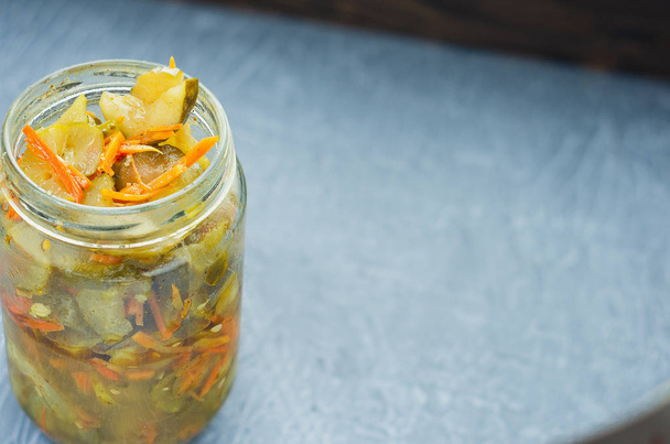 pickled fermented cucumbers and carrots in a jar. - Photo, Image