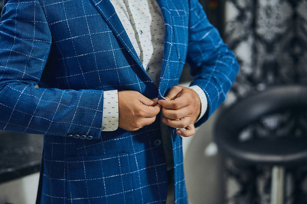 Businessman wears a jacket,male hands closeup,groom getting ready in the morning before wedding ceremony - 写真・画像