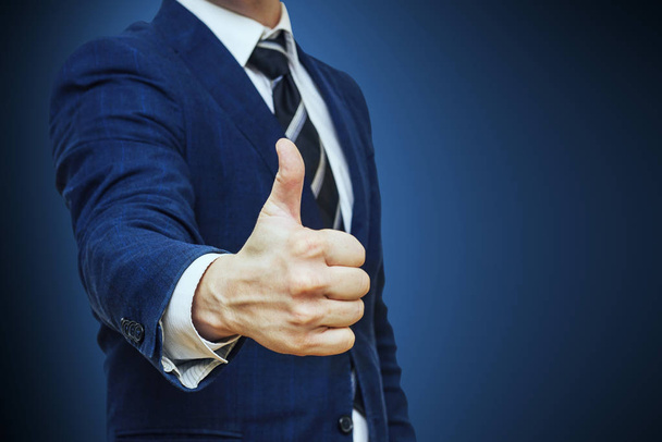 Businessman shows thumb up sign gesture. Nonverbal communication. Like, OK, perfect, good job, praise, satisfied, thumb up gesture of businessman - Fotografie, Obrázek