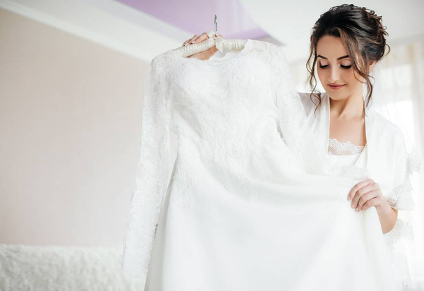 Beautiful young bride  posing with  white wedding dress  - Photo, Image