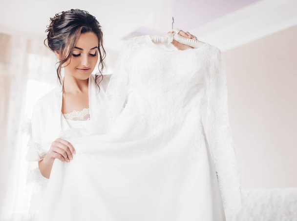 Beautiful young bride  posing with  white wedding dress  - Photo, image