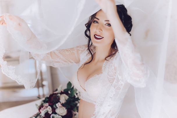 Beautiful young bride in white wedding lingerie - 写真・画像