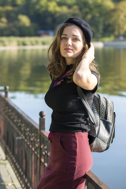 The girl in beret and skirt in the park, Cute girl portrait in french style - 写真・画像