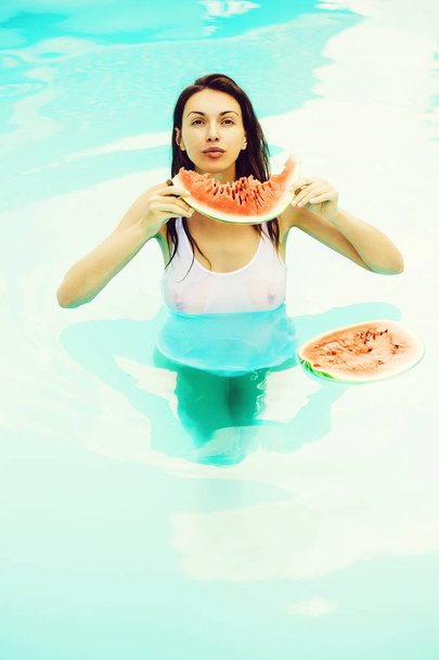 sexy woman with watermelon in pool - Fotoğraf, Görsel