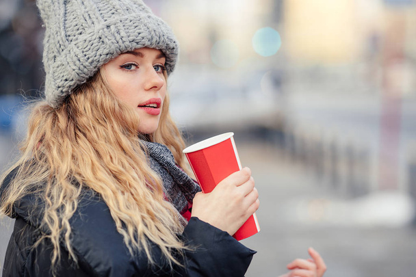 Woman Drink Her Hot Coffee While Walking On The Street. Portrait Of Stylish Smiling Woman In Winter Clothes Drinking Hot Coffee. Female Winter Style. - Image - Foto, Bild
