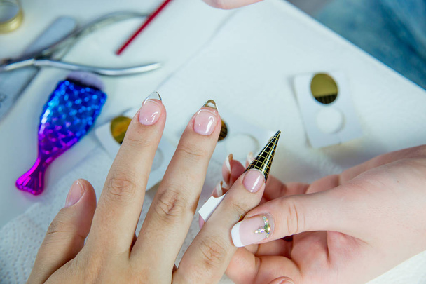 nail care and manicure in a nail salon - Fotoğraf, Görsel