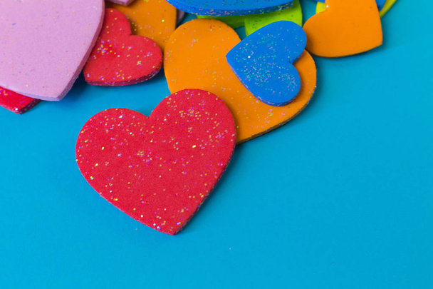 The multi colour  heart on blue background close up image. - Foto, Imagen