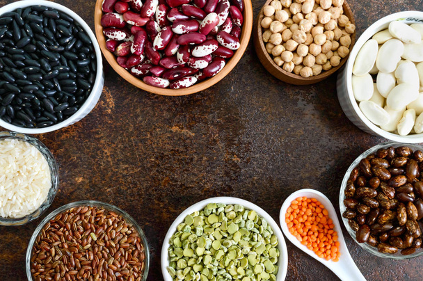 Healthy food, dieting, nutrition concept, vegan protein source. Assortment of colorful raw legumes: lentils, green peas, beans, chickpeas, rice in bowls. Background. Free space. - Fotó, kép