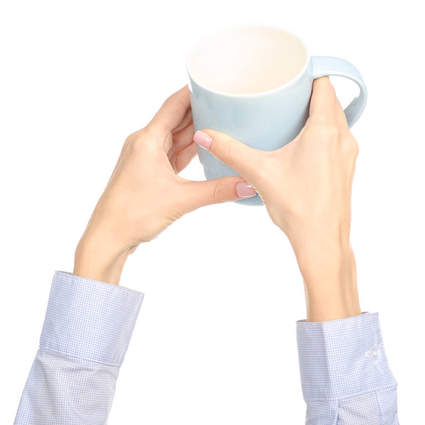 Blue cup mug in hand arm raised up - 写真・画像