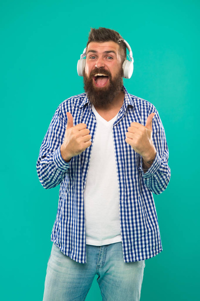 Happy man hipster listen to music. Mature hipster with beard. Bearded man. Hair and beard care. music. brutal caucasian hipster with moustache. Man in earphones. Young and brutal. perfect paly list - Foto, Imagen