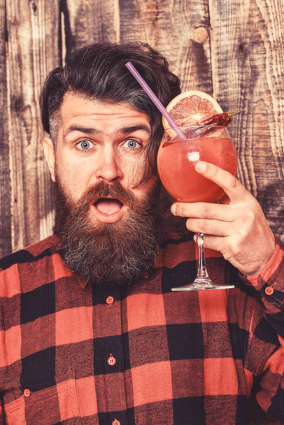 Hipster enjoy strong drink or cocktail. Man holds alcohol cocktail - Photo, image
