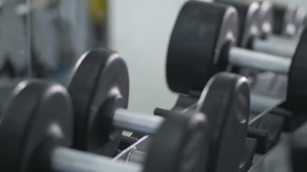 Close-up. Male hands put dumbbells on the rack 4K Slow Mo - Footage, Video