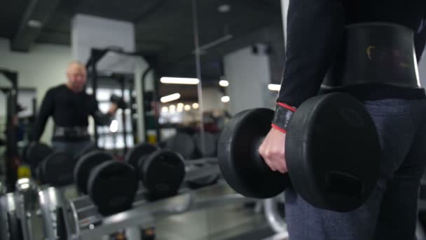 Close-up. Male hand lifts the dumbbell 4K Slow Mo - Footage, Video