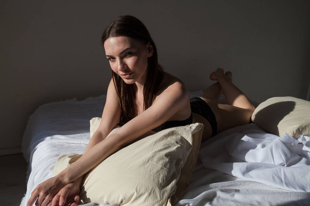 beautiful woman in underwear lies on the bed in the bedroom the morning sleep - Φωτογραφία, εικόνα
