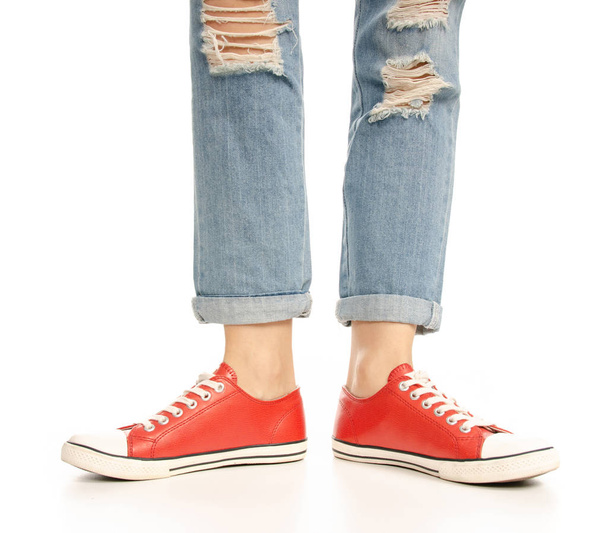 Woman legs feet jeans red sneakers hipster style - Foto, immagini