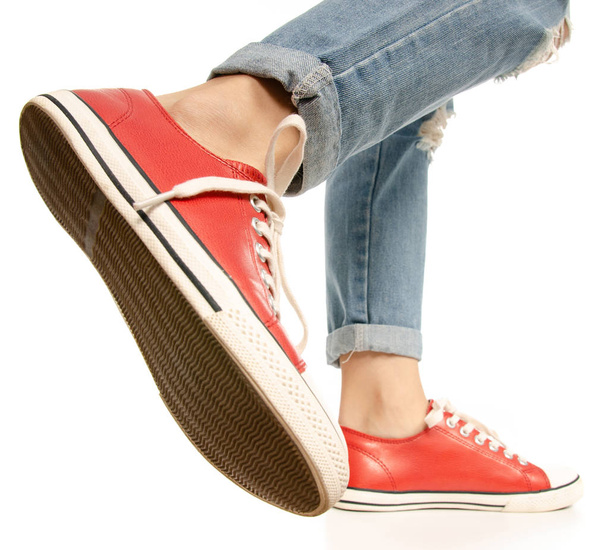 Woman legs feet jeans red sneakers hipster style - Foto, immagini