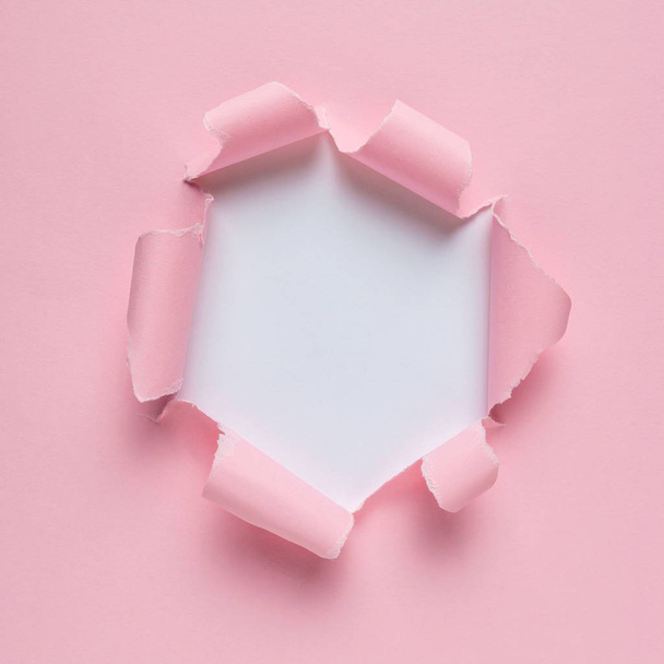 Vivid pink ripped paper with burst hole background. Minimal abstract concept. - Фото, изображение