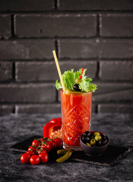 photo of delicious tomato bloody mary cocktail on reflecting stone table with spot light - Φωτογραφία, εικόνα