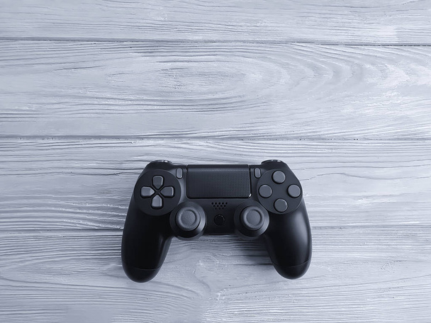 black game controller on wooden background - Foto, imagen