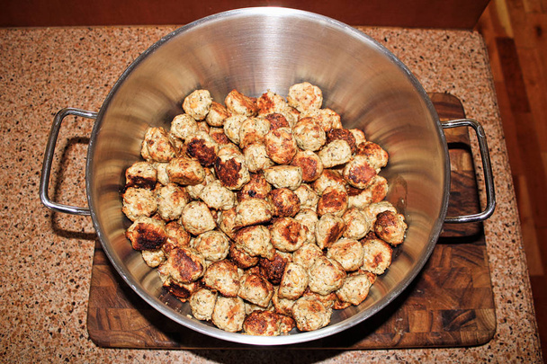 Baked meatballs piled into a silver pot - Photo, Image