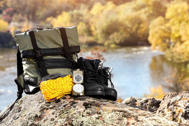 Set of camping equipment on rock outdoors. Space for text - Fotó, kép