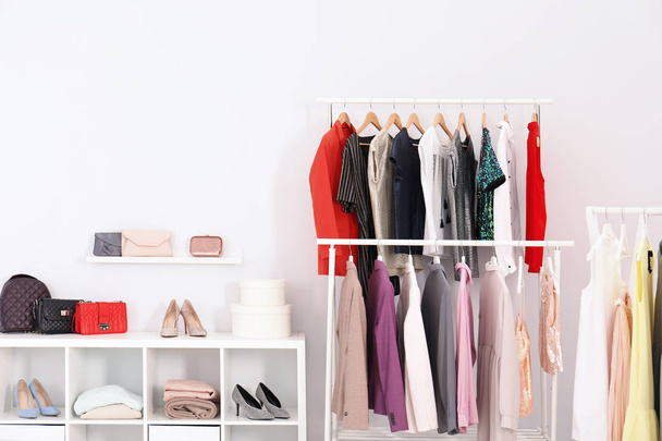 Racks with clothes in stylish dressing room interior - Photo, Image