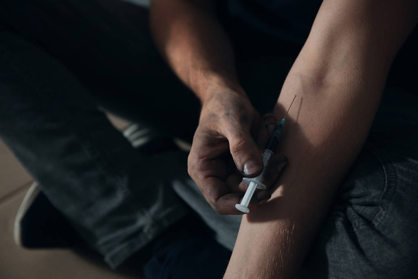 Male drug addict making injection, closeup of hands - Фото, изображение