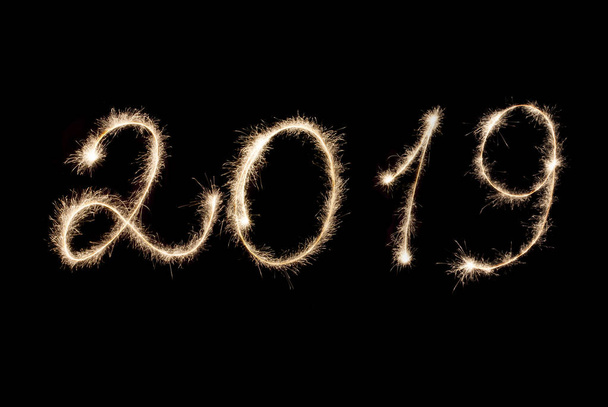 Happy New Year 2019 inscription sparklers on a black background. - Photo, image